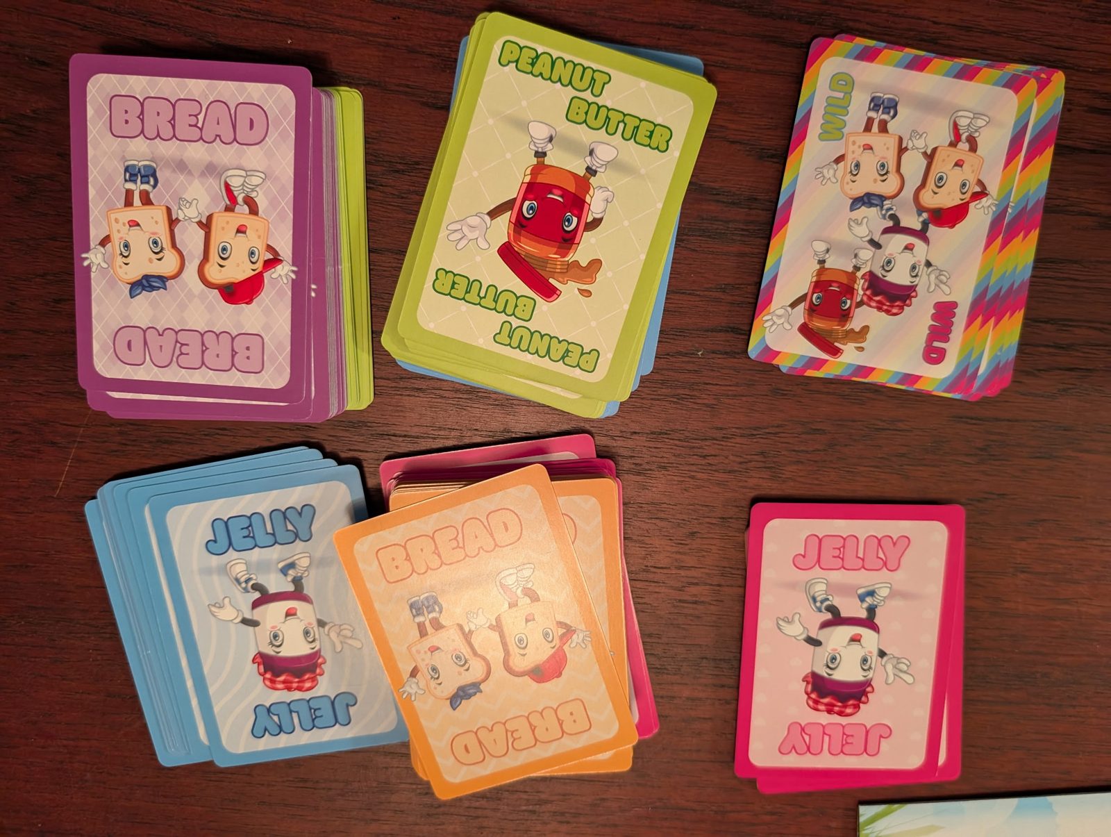 Bread, Peanut Butter, Jelly, and Wild cards spread out on a table